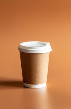 Sıfır Atık Yaşam Tarzı, Tek Kullanılabilir Kahverengi Kupa Beyaz Plastik Lid ile kahverengi arka plan izole.
