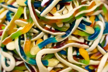 Candy background, chewing jelly candies in the form of worms, close-up.