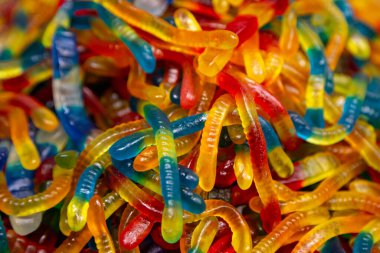 Candy background, chewing jelly candies in the form of worms, close-up.