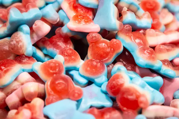 Background of chewing gelatin sweets in the form of bears, close-up.