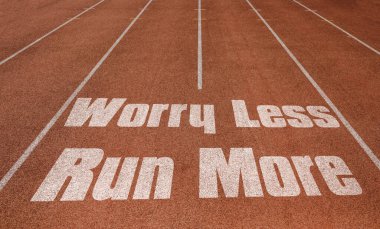 Worry Less Run More written on running track, New Concept on running track text in white color