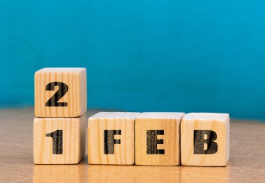 Cube shape calendar for February 21 on wooden surface with empty space for text,cube calendar for december on wood background