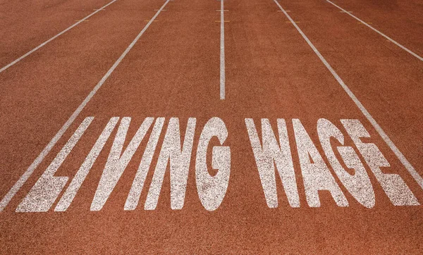 Living Wage written on running track, New Concept on running track text in white color