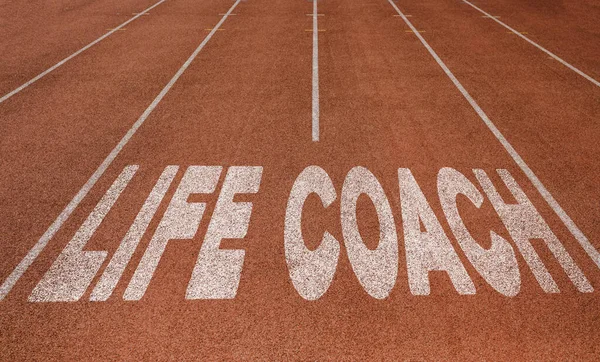 Life Coach written on running track, New Concept on running track text in white color