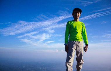 Metin mesajınız için gökyüzü arkaplanına karşı tepe üzerinde bir dağcının portresi