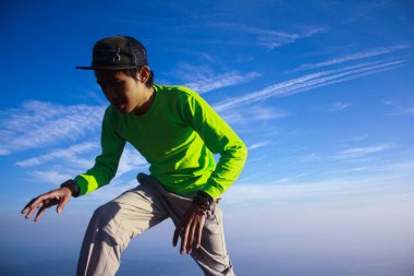 Mavi gökyüzü arka planında sallanan bir adam