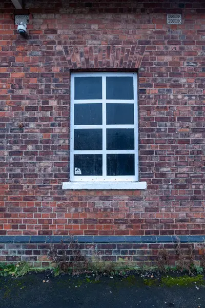 window of an old brick wall with a red and yellow bricks. background.