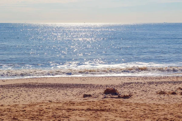 Sunlight reflecting on sparkling blue sea at Southwold beach, a popular seaside town of the UK
