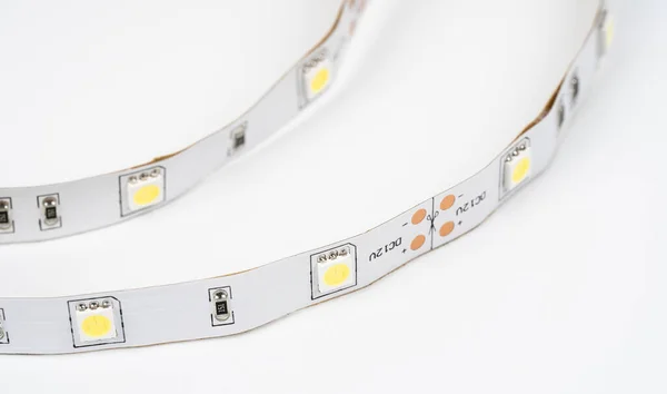 Unwinding Roll of LED Lights Cut Out. Diode strip. Led lights tape close-up