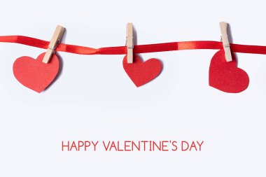 Valentine's Day. Paper hearts on a pastel background. Abstract background with paper-cut shapes. Saint Valentine