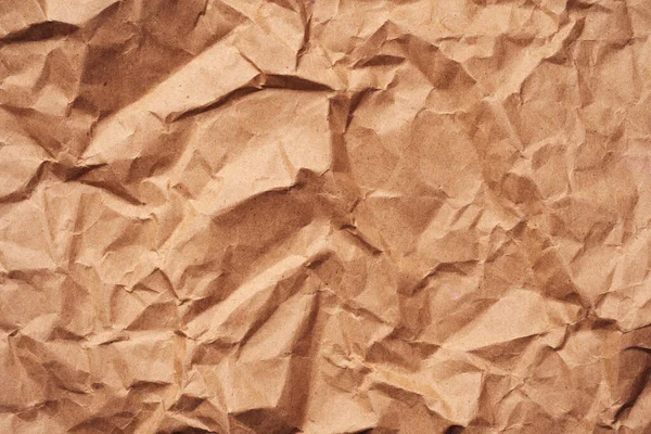 Brown crumpled recycled paper texture background. Textured paper background. Kraft Paper texture background of brown crumpled recycled cardboard paper sheet