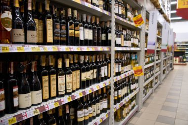Ukraine, Dnipropetrovsk. 05.06.2021 A variety of alcohol in glass bottles on the counter in the supermarket. Alcohol store.