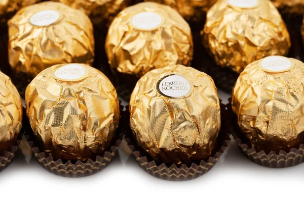 stock image Dnipro. Ukraine 05.03.2023: Ferrero Rocher chocolate and hazelnut confectionery balls. Ferrero Rocher is a chocolate sweet made. Chocolate candies in a gold wrapper. Luxurious Design