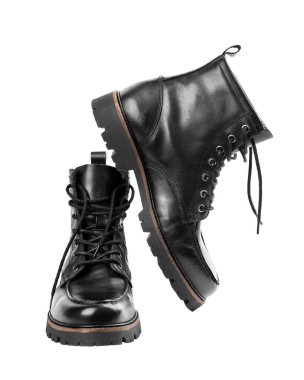 Pair of black leather boots, dress boots for men, men ankle high boots. Black brogue boots on a white background. Men fashion in leather boots. Man's legs in black jeans and brown leather boots.