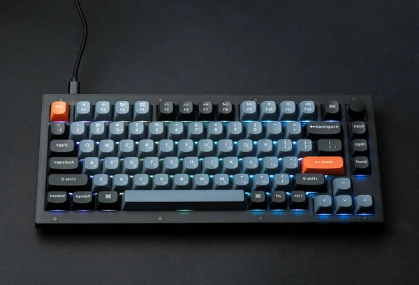 Modern mechanical keyboard for your computer. Gray keyboard with orange accent keys