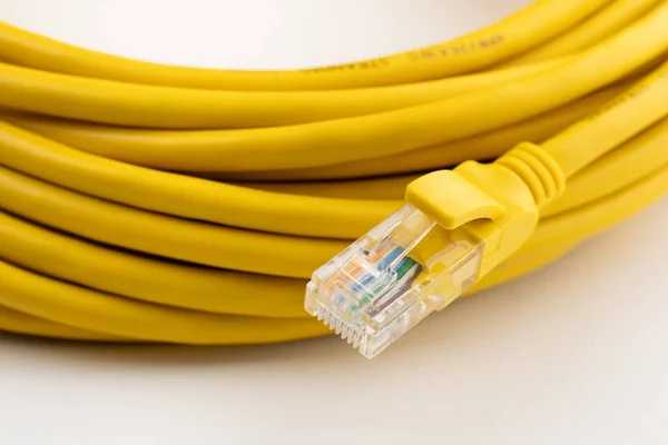 yellow network cable, isolated on white background. Closeup LAN cables with connector. Lan cable for internet network connection, gray lan cable on a white background. Ethernet network cable roll.
