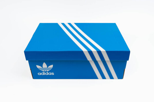 Днепр, Украина - 08.05.2024: Adidas branded shoe box in blue with white stripes. Логотип Adidas.
