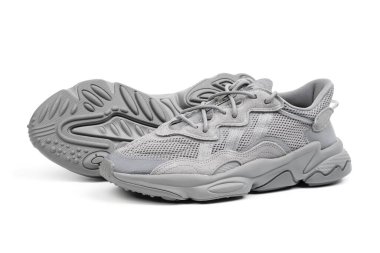 Dnipro, Ukrayna - 05.08.2024: Arka planda izole edilmiş gri adidas spor ayakkabılarına yakın görüş. Gri Adidas Sneakers ve Kutu Saydam Kaydırma Çekimi Mağaza Masasında.