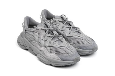 Dnipro, Ukrayna - 05.08.2024: Arka planda izole edilmiş gri adidas spor ayakkabılarına yakın görüş. Gri Adidas Sneakers ve Kutu Saydam Kaydırma Çekimi Mağaza Masasında.