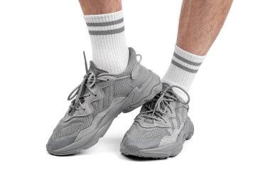 Dnipro, Ukrayna - 05.08.2024: Arka planda izole edilmiş gri adidas spor ayakkabılarına yakın görüş. Gri Adidas Sneakers ve Kutu Saydam Kaydırma Çekimi Mağaza Masasında.