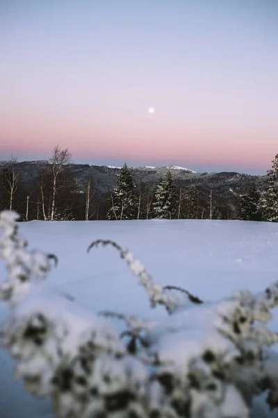 Stock image beautiful pink sunrise in mountains covered with snow and clouds