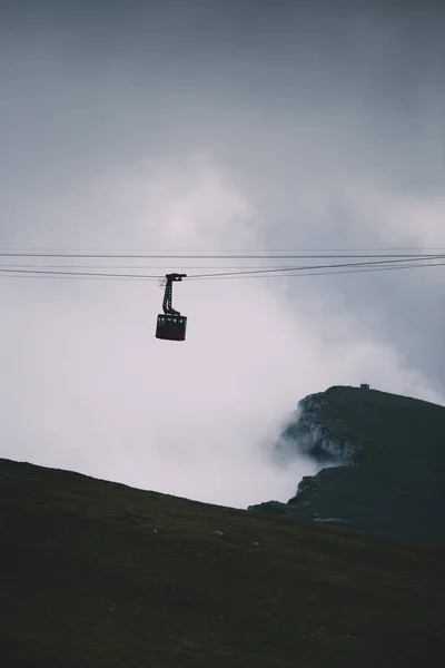 Cableway over the foggy valley in the mountains