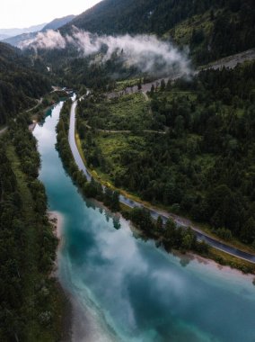 Foggy Aerial landscape. Azure mountain lake and misty forest from above. Austria, Tirol, Europe