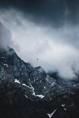 Cableway over the foggy valley in the mountains