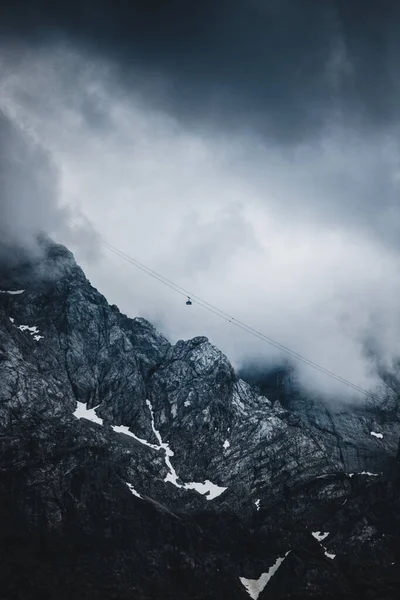 Cableway over the foggy valley in the mountains