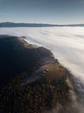 Romano Catholic chapel at Perko Sanzieni village, Covasna county Romania, Transylvania. Captured from above with drone at sunrise  clipart