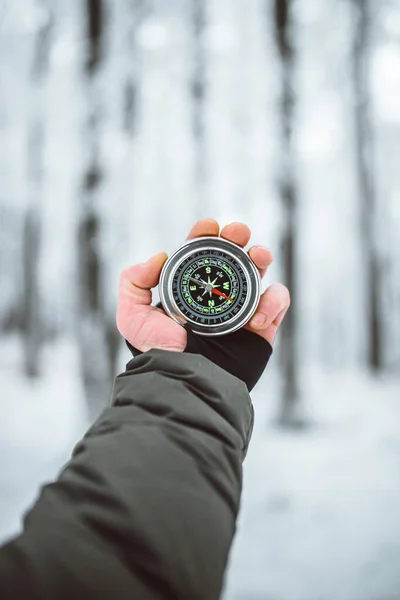 stock image man holding compass in hand at winter time 