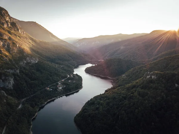 Aerial view of crystal clear Lake in Romania. Fantastic autumn sunset background. Location: Lake Prisaca, National Park Domogled - Valea Cernei.