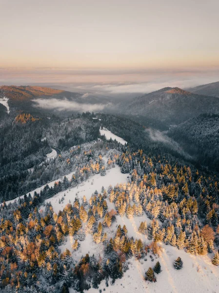 Moody aerial drone idyllic winter landscape in sunrise. View from the top of the mountain. Hipster, vintage, abstract style 