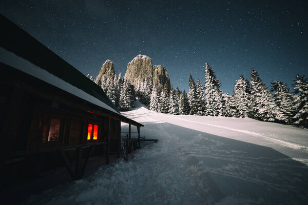 beautiful winter landscape with a small house in the mountains