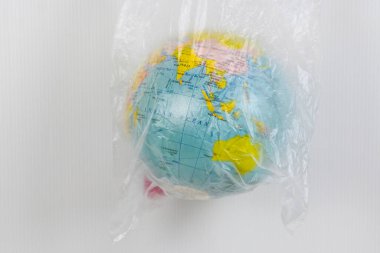 Dünya atlası beyaz zemin üzerinde plastik torba içinde, kopyalama alanı, çevre dostu, dünyayı kurtar, plastik torba yok, kirlilik konsepti atık tasarrufu çevreyi sürdürülebilir kavramı azaltır