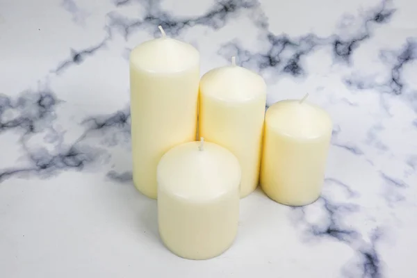 White candles on white background isolated. Set of wax candles, home & Christmas decor