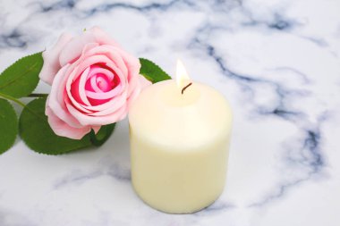 Light White candle pink rose, creating sacred ritual meditation, spiritual healing. Self love and home interior decoration.