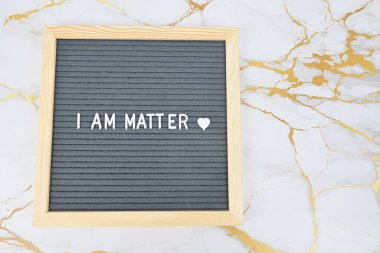 Grey letter board with phrase I am matter, self love, self care. Mindfulness lifestyle, mental health. Aspiration and supportive sentence clipart