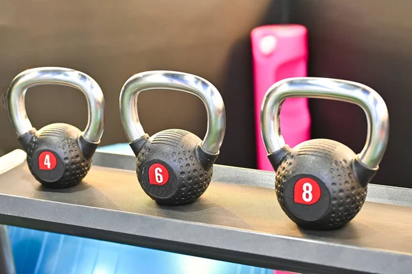 Rack with sports kettlebell weights kilograms of weight, equipment for sports fitness on the shelf in the gym store. concept sports exercises.Self love self care, healthy lifestyle.