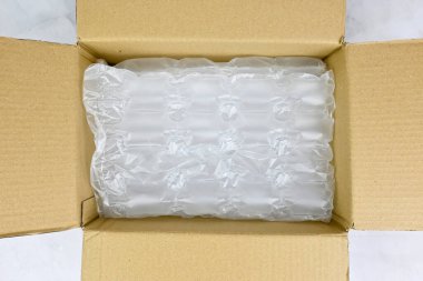 Open up delivery box filled with plastic bubble wrap. Bubble wrap, made up of low-density polyethylene (LDPE), falls into the category of plastics not placed in curbside recycling.