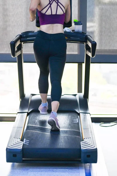 Young sport woman sweat running on treadmill in gym, Self care time by work out exercise, mindfulness lifestyle