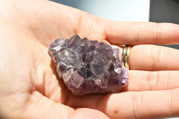 Closed up of healing crystal amethyst, seven chakra, pineal gland. Spiritual new age mindfulness lifestyle