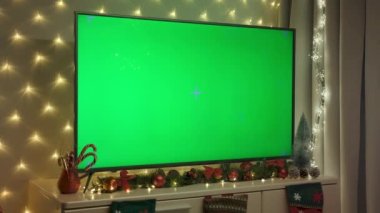 Christmas TV with green screen compositing on the table. Christmas time High quality 4k footage