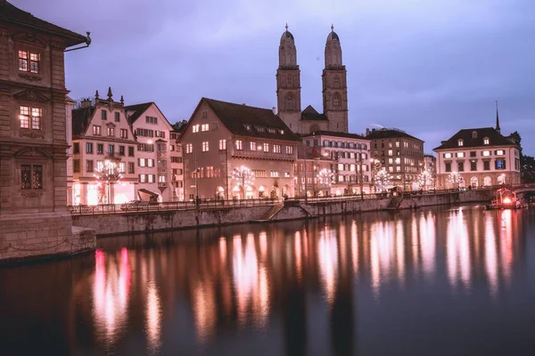 stock image VIew of Grossmunster Church across the Limmat River in Zurich, Switzerland
