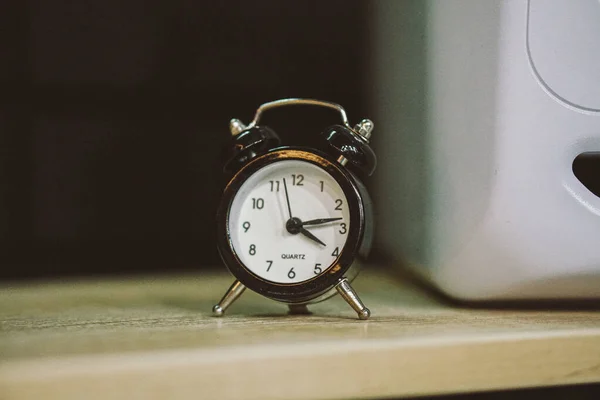 old alarm clock on a black background.