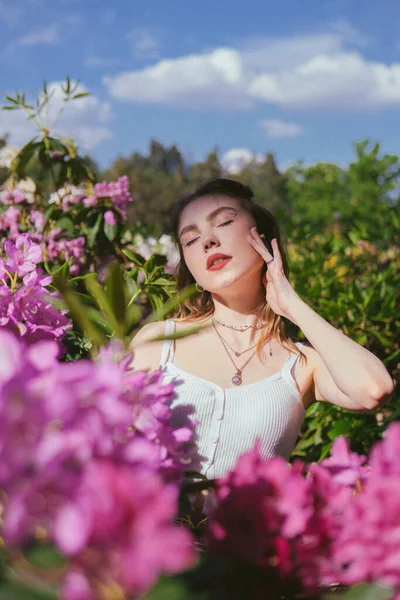 stock image beautiful young woman in a pink dress in the park