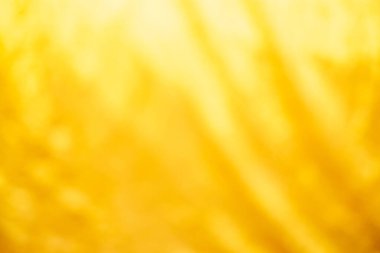 Sarı çarşaf deseni bulanık eğri tarzı soyut lüks kumaş, kırışık çarşaf ve altın rengi gölgeler, arka plan.