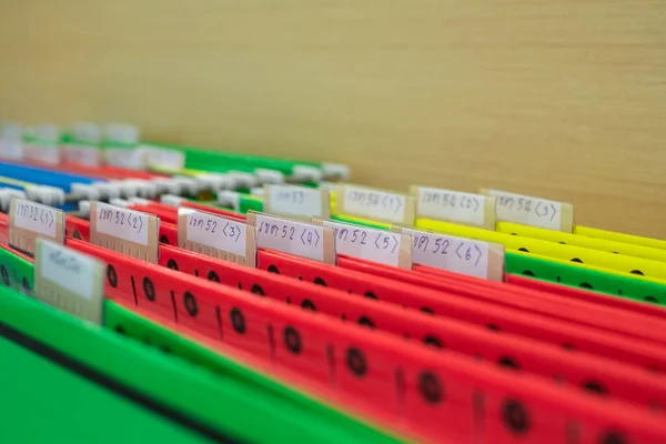 Financial document files arranged in filing cabinets.
