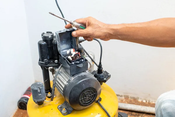 The technician is repairing the broken water pump. Caused by the service life of the equipment And it\'s time to replace