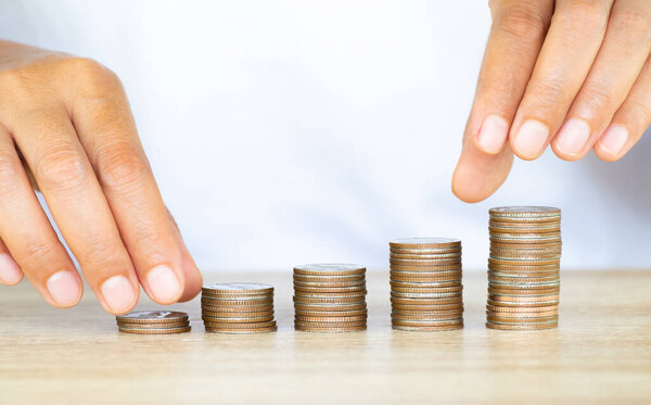 Saving money concept preset by Female hand putting money coin stack growing business, Saving money for future plan for life, management cash